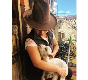 Rosa at her home with a lamb from her flock / photo by H. Moulton.