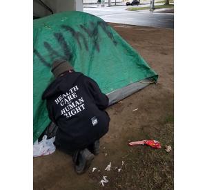 A health outreach worker at an encampment in Eugene / photo by Mackenzie VanLaar.