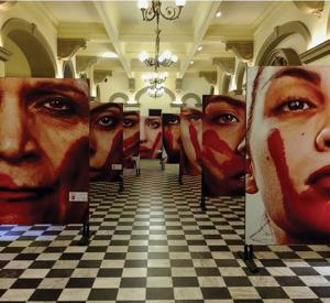 Marcio Freitas’ “Nunca Me Calarei” (I Will Never be Silenced) features the faces of women who have experienced gender-based violence in Brazil / photo by Emily Masucci.