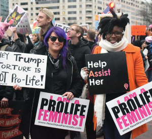 New Wave Feminists founder Destiny Herndon-De La Rosa (left) was interviewed by Strait at the annual Pro-Life Women's Conference in June 2018. In this photograph, taken in 2017, De-La Rosa had traveled from Dallas to attend both the Women's March and the March for Life. She says the movements shouldn't be seen as working against one another. At the end of the day, both “love women, and we want to help them.” Photo by Gretchen Frazee/PBS Newshour. Used by permission from NPR.