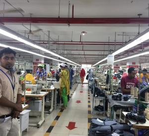 Workers at a compliant factory that has met all safety checks after the 2013 industrial accident. Line supervisor is on the far left.
