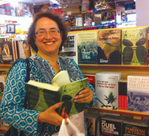 Anita Weiss stands beside two recent coedited books at Saeed Book Bank, Islamabad, August 2014. 