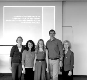 Kali Lantrip stands in the center of this image from her dissertation defense, flanked by her committee. From left, Beth Stormshak, PhD; Krista Chronister, PhD, Dissertation Chair; Kali Lantrip; Jeff Todahl, PhD; and Debra Eisert, PhD.