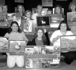Shannon Elizabeth Bell, front center, with Harts Photovoice Group at their 2009 exhibit in West Virginia. Bell served as a bridge to help women she studied bring forward their stories about devastation to their community by the coal industry.