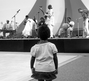 A young girl watches the performance of musicians at a meeting of an association of immigrants from Mauritania, West Africa, in Paris, France.