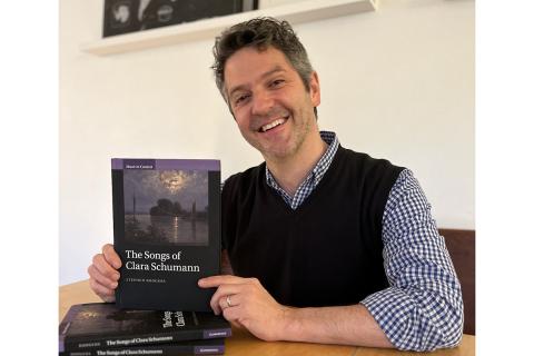 Stephen Rodgers, Professor and Edmund A. Cykler Chair in Music, holding the copy of his book, "The Songs of Clara Schumann"