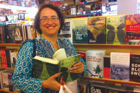 Anita Weiss stands beside two recent coedited books at Saeed Book Bank, Islamabad, August 2014. 