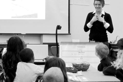 Philosophy graduate student Megan Burke talks about women’s roles in agriculture to a class of first graders at the 4J French Immersion school in south Eugene (photo by Alice Evans).