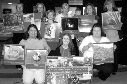 Shannon Elizabeth Bell, front center, with Harts Photovoice Group at their 2009 exhibit in West Virginia. Bell served as a bridge to help women she studied bring forward their stories about devastation to their community by the coal industry.