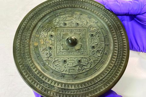Back of a bronze mirror showing a decorative design, from storage at the Seattle Art Museum / photo by Yuan Fang
