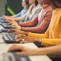 Students typing in a computer lab.