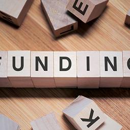 Wooden blocks spell out the word Funding.