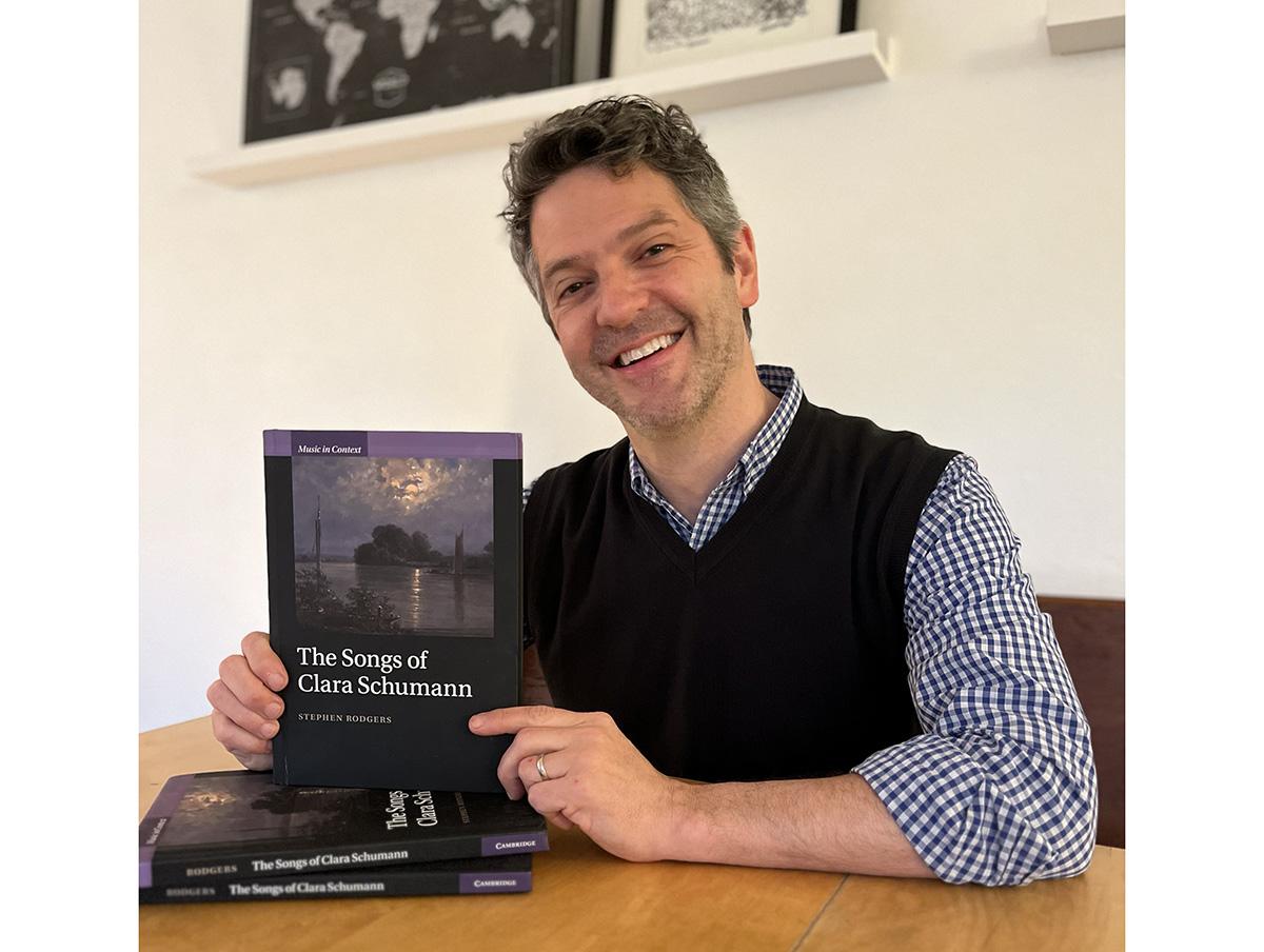 Stephen Rodgers, Professor and Edmund A. Cykler Chair in Music, holding the copy of his book, "The Songs of Clara Schumann"