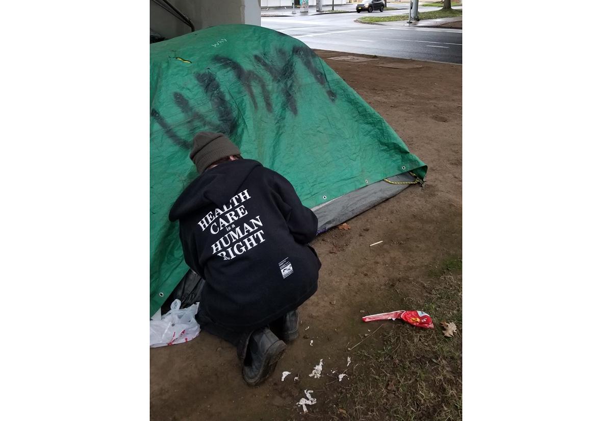A health outreach worker at an encampment in Eugene / photo by Mackenzie VanLaar.