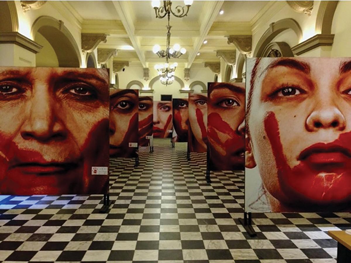 Marcio Freitas’ “Nunca Me Calarei” (I Will Never be Silenced) features the faces of women who have experienced gender-based violence in Brazil / photo by Emily Masucci.