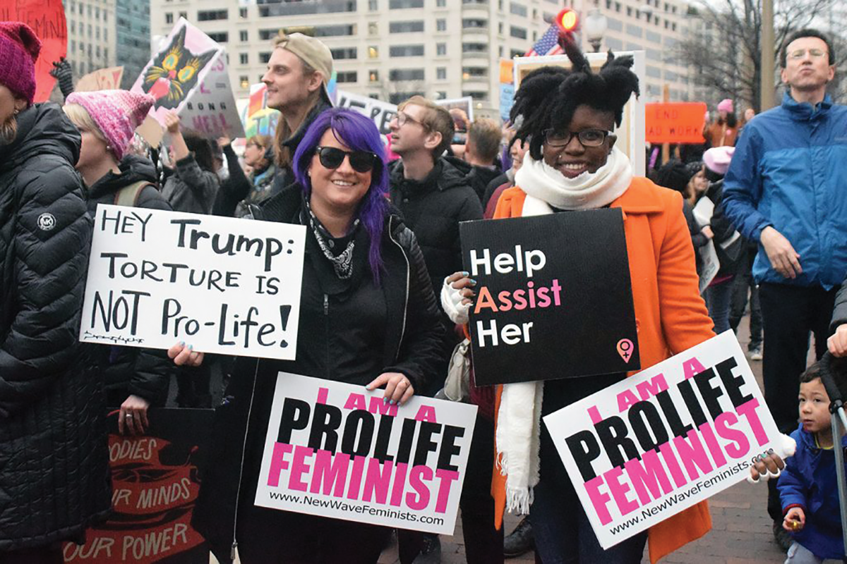 New Wave Feminists founder Destiny Herndon-De La Rosa (left) was interviewed by Strait at the annual Pro-Life Women's Conference in June 2018. In this photograph, taken in 2017, De-La Rosa had traveled from Dallas to attend both the Women's March and the March for Life. She says the movements shouldn't be seen as working against one another. At the end of the day, both “love women, and we want to help them.” Photo by Gretchen Frazee/PBS Newshour. Used by permission from NPR.