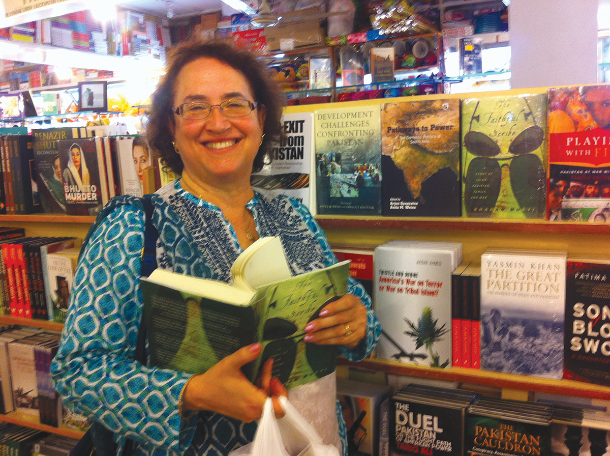 Anita Weiss stands beside two recent coedited books at Saeed Book Bank, Islamabad, August 2014.