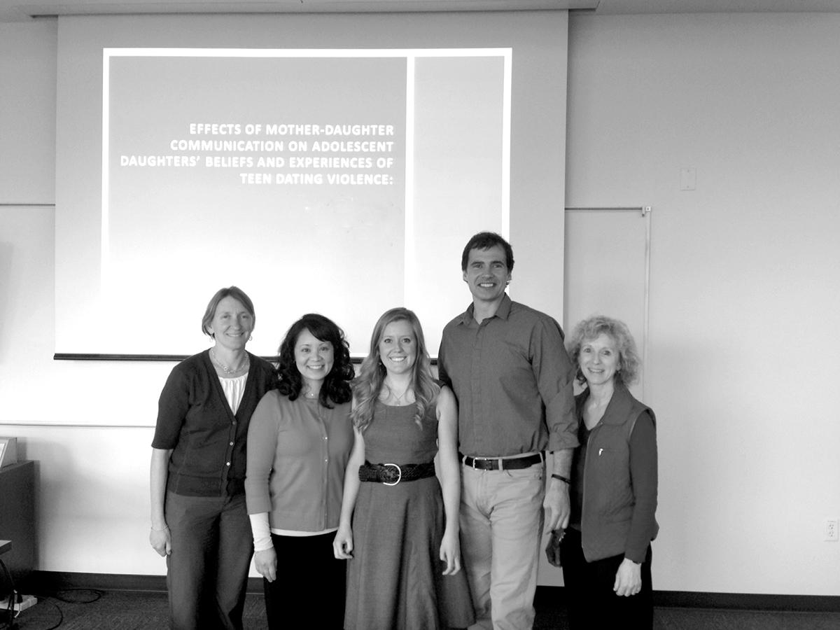 Kali Lantrip stands in the center of this image from her dissertation defense, flanked by her committee. From left, Beth Stormshak, PhD; Krista Chronister, PhD, Dissertation Chair; Kali Lantrip; Jeff Todahl, PhD; and Debra Eisert, PhD.
