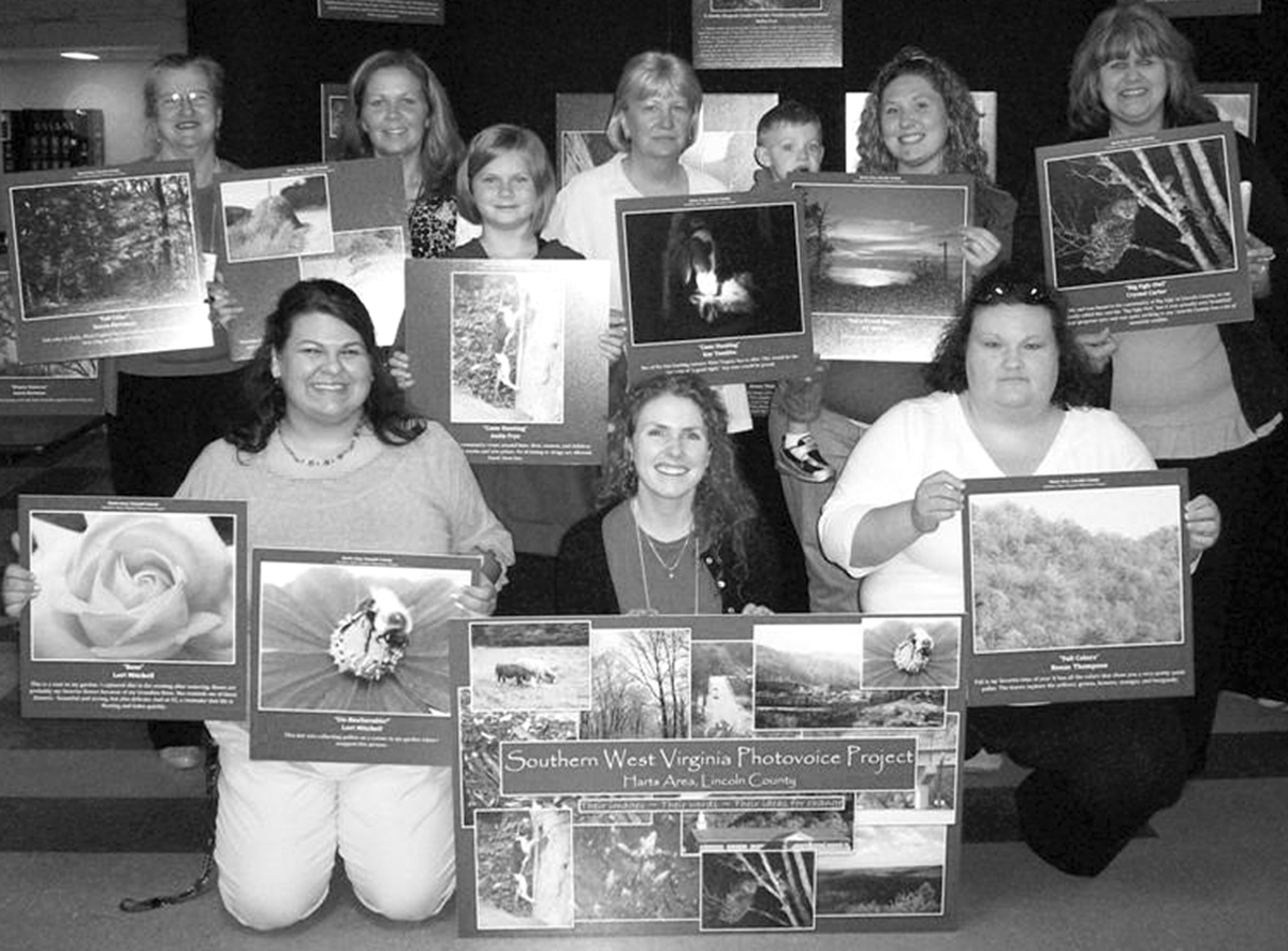 Shannon Bell, front center, with the Harts Photovoice Group at their exhibit in West Virginia, April 2009.