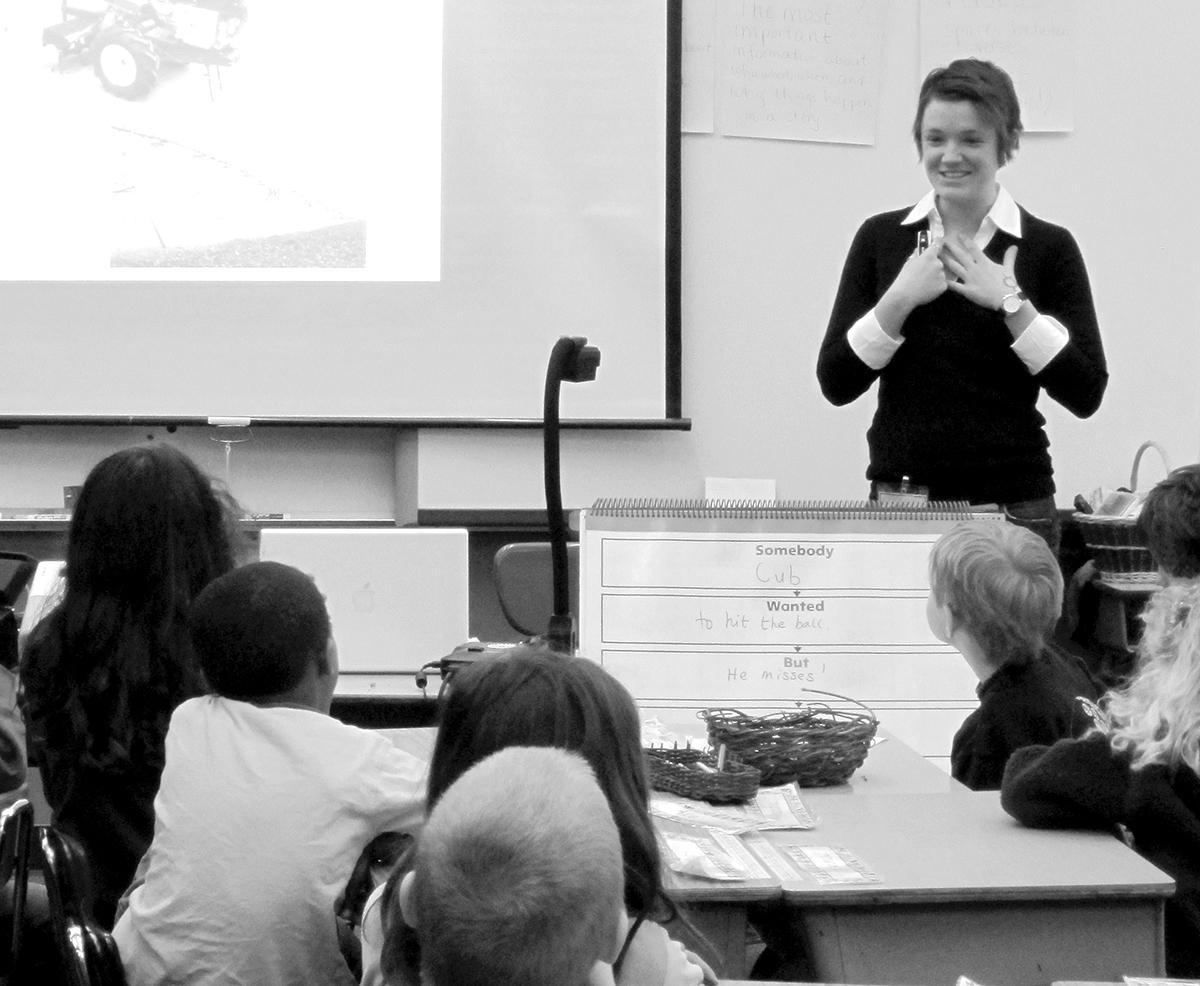 Philosophy graduate student Megan Burke talks about women’s roles in agriculture to a class of first graders at the 4J French Immersion school in south Eugene (photo by Alice Evans).