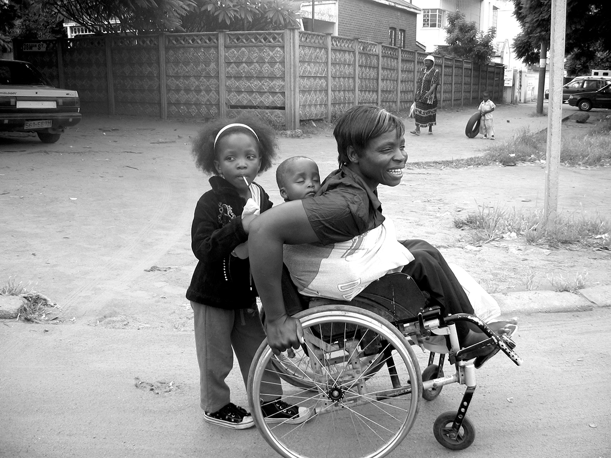 Irene Moyo, pictured here with her children, received a loan for her street vending business from research collaborating organization Zimbabwe Women with Disabilities in Development (ZWIDE).