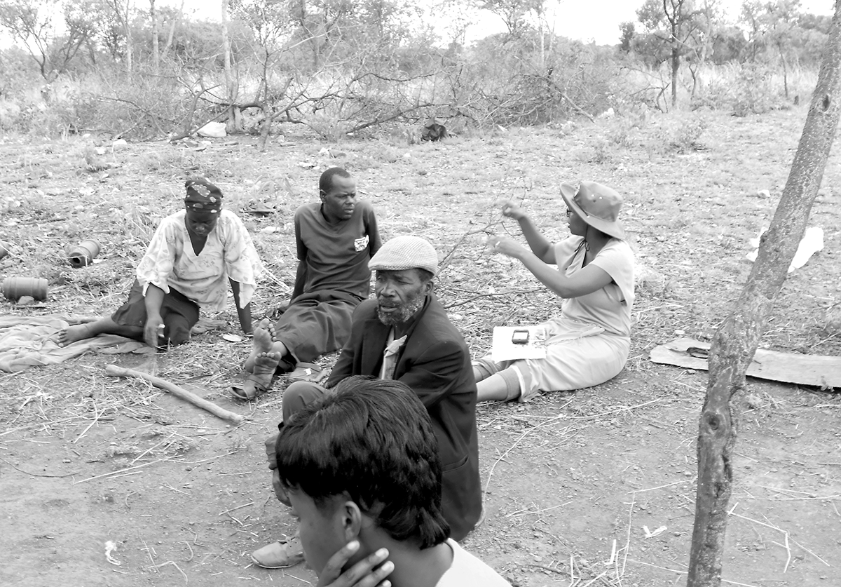 Easther Chigumira, far right, conducts a household interview. The author notes that the presence of males at most interviews is indicative of the male/female dynamics in her study area. She found it difficult to interview women alone, but when she was able to do so, they spoke freely. With men or boys present, women tended to defer questions to the male. 