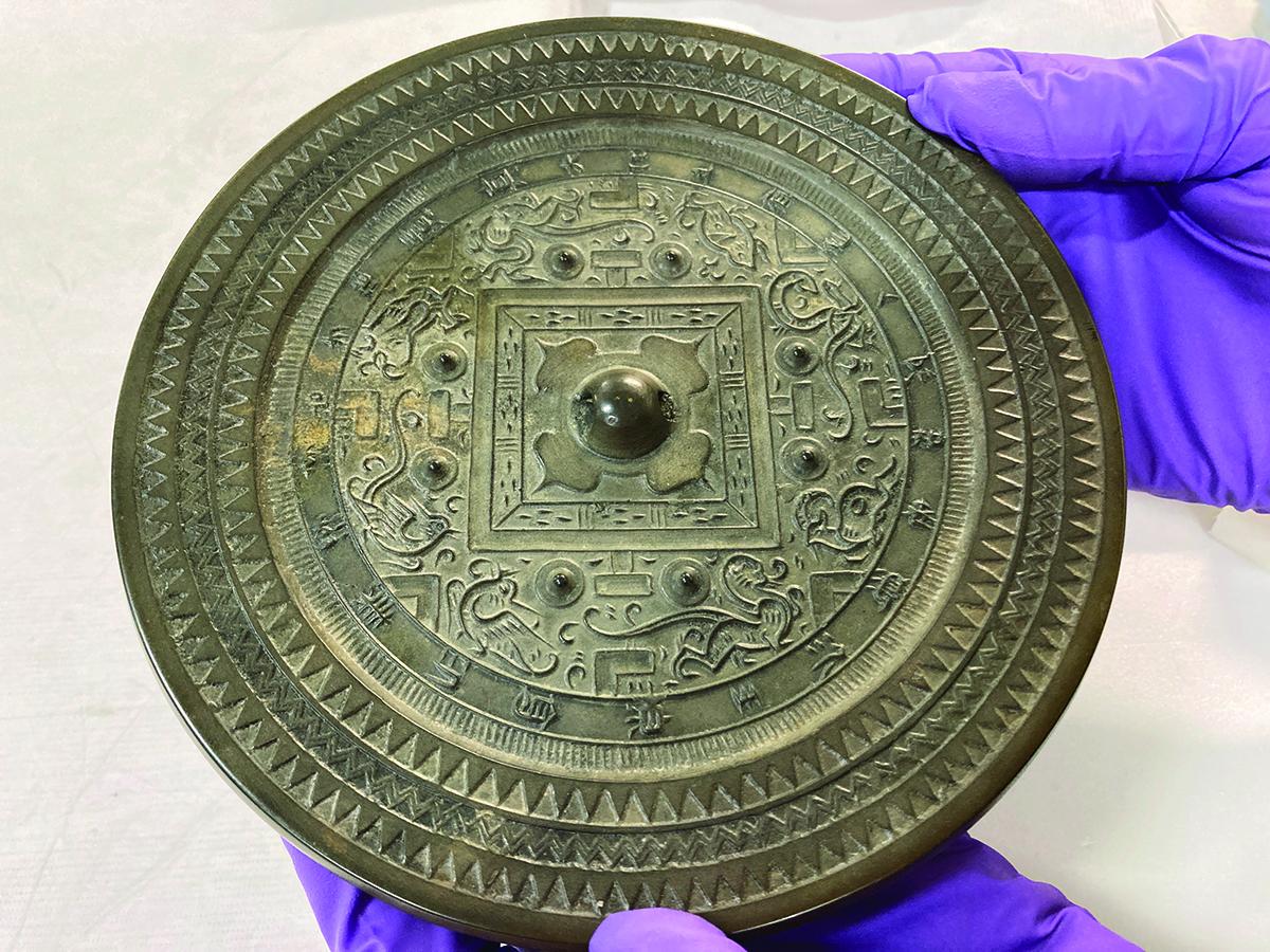 Back of a bronze mirror showing a decorative design, from storage at the Seattle Art Museum / photo by Yuan Fang