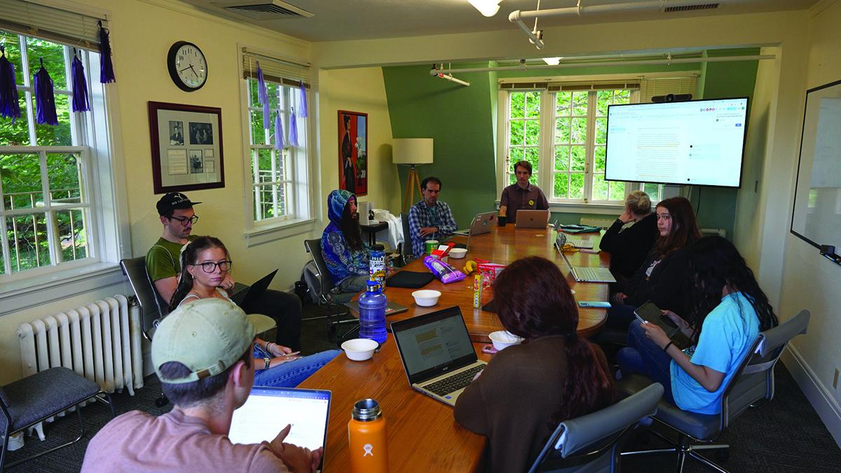 Sitting around the CSWS Jane Grant Room conference table, students offer both generative and critical feedback on their op-ed assignment drafts in the HIST 416 Calderwood Seminar last spring / photo by Owen Garvey.