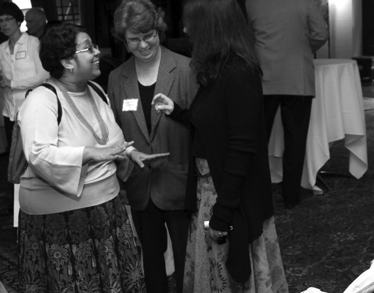 At a 2010 CSWS reception, Sangita Gopal (left) talks to colleagues Gabriela Martínez and Cecelia Enjuto Rangel while her daughter, Mohini, looks on (photo by Jack Liu).