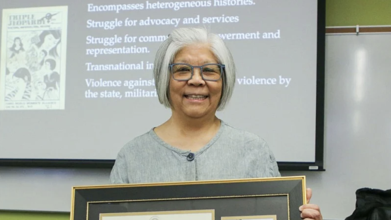 Photo of Lynn Fujiwara receiving the award.