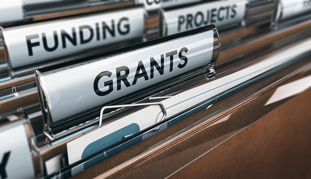 Hanging folders in a cabinet labeled funding, projects, and grants.
