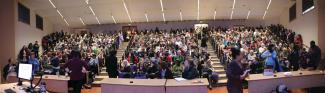 Panorama of the full house at Lillis Hall preceding Walidah Imarisha’s talk “Why Aren’t There More Black People in Oregon?: A Hidden History” / photo by Jack Liu