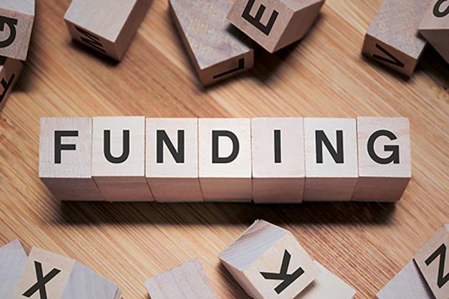Wood blocks spell the word funding.