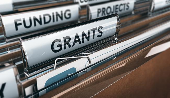 Hanging folders in a cabinet labeled funding, projects, and grants.